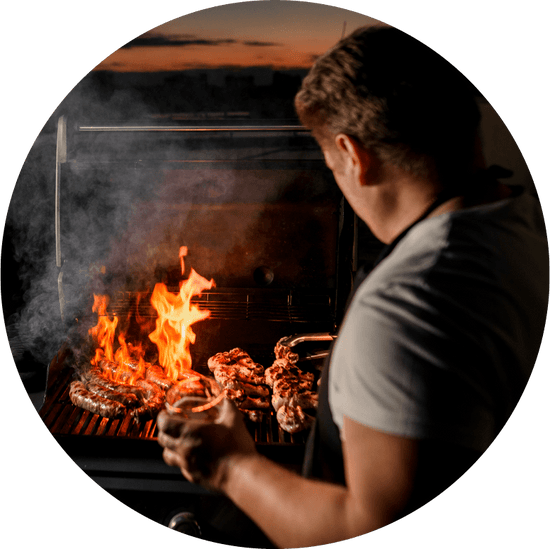 man grilling over flaming bbq